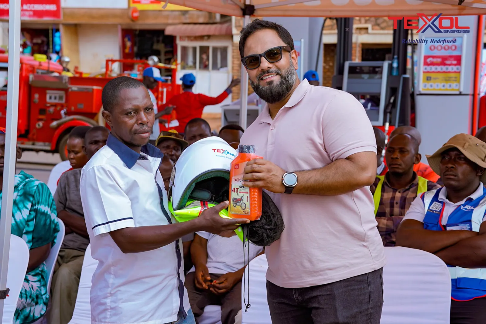 A rider receives a prize helmet and TexLube oil